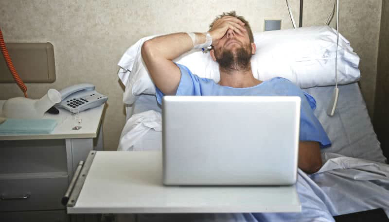 A man in a hospital bed with car accident injuries regrets posting details to his social media account.