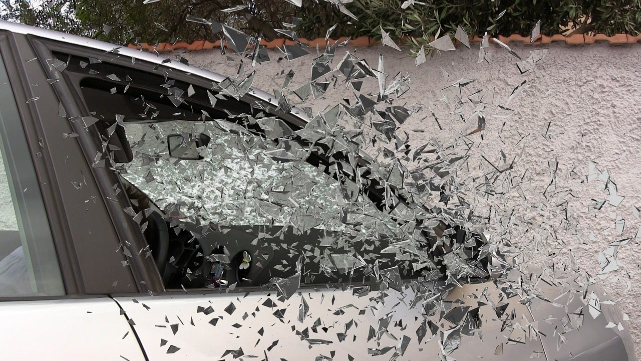 Glass shatters from the passengers side window during an accident but the driver is uninsured.