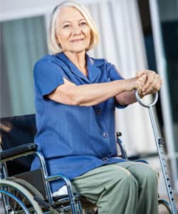 nursing home resident sitting in chair and smiling