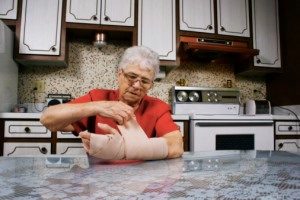 person wrapping a wound at home