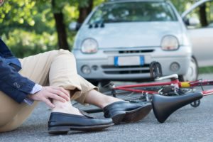 pedestrian hit by a car laying on the pavement